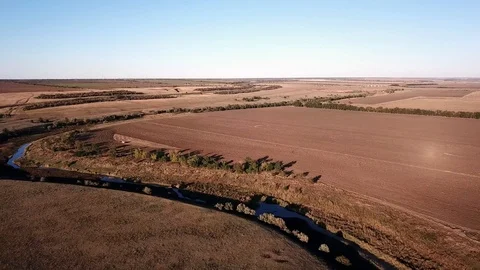 A small river flows among the endless fields Stock Footage 97027463