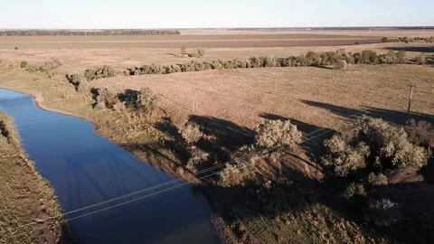 A small river flows among the endless fields Stock Footage 97027502