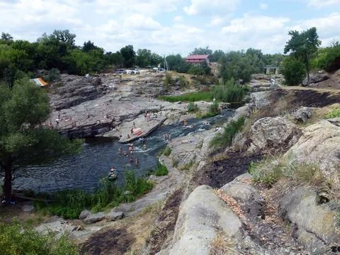 A small river flows between the picturesque rocks, on the banks Stock Photos