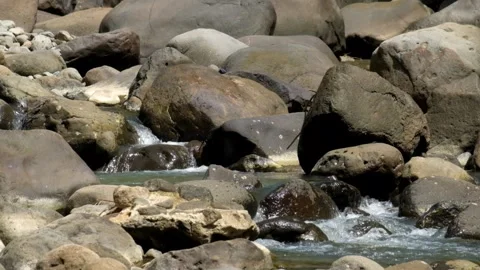 A small river flows quietly between the rocks Stock Footage 336877459