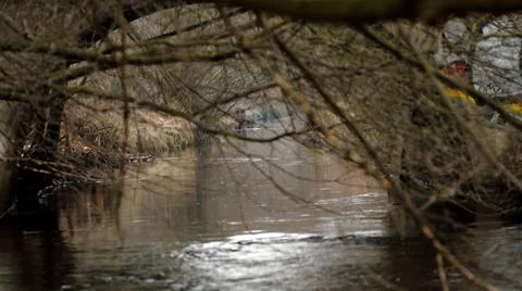 A small river that flows through the city in early spring Stock Photos
