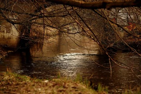 A small river that flows through the city in early spring Stock Photos