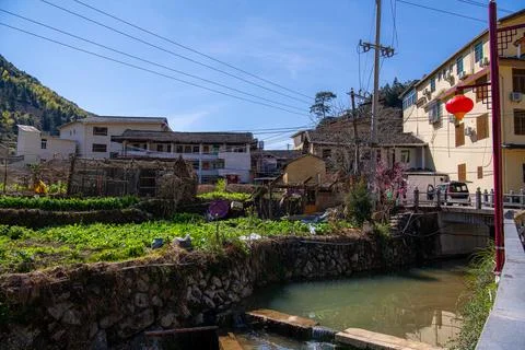 Small river in front of Fujian earthern buildings in mountains, Fujian, China Stock Photos