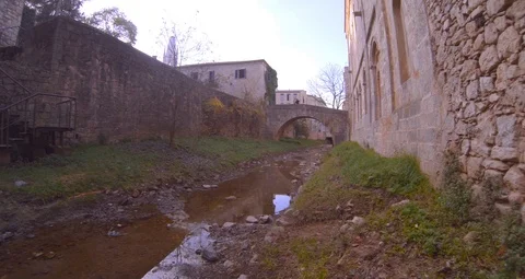 Small river going down through the oldtown at afternoon Stock Footage 104065663