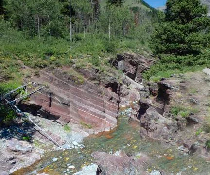 A small river in the mountains with forest Stock Photos