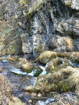 Small river in the mountains, water between rocks Stock Photos