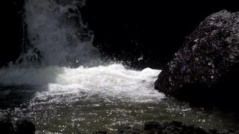 Small river in the mountains with a waterfall flowing rapidly Stock Footage 319877437