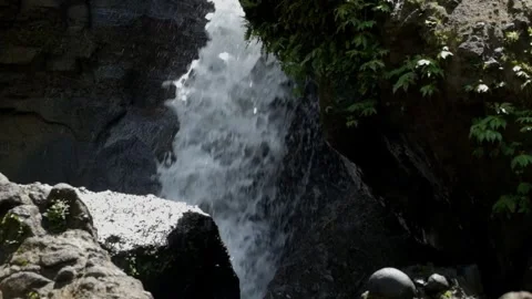 Small river in the mountains with a waterfall flowing rapidly Видео 319877458