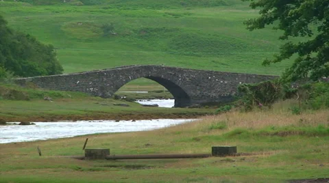 Small river with an old stone bridge in the Hebrides Stock Footage 39815442