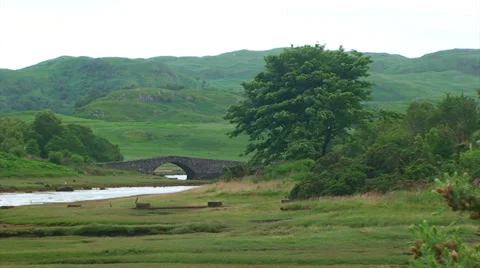 Small river with an old stone bridge in the Hebrides Stock Footage 39815453