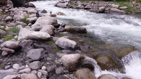 A small river passing through rocks in Ghizer Valley Stock Photos