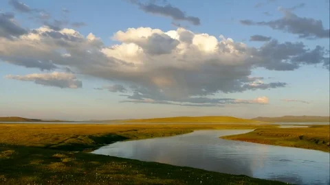 Small river on a plain against the distant hills and picturesque sky.Timelapse. Stock Footage 82222087