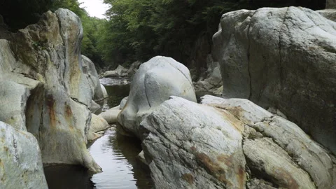 A small river running through large rocks Stock Footage 131758491