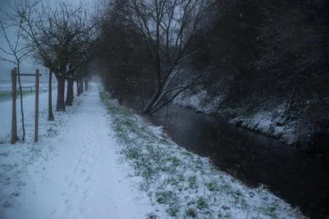 Small river in snowy forest Stock Photos