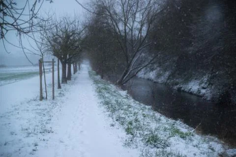 Small river in snowy forest Stock Photos