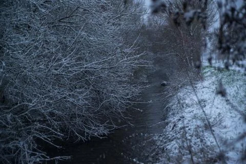Small river in snowy forest Stock Photos