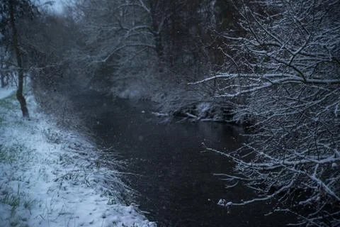 Small river in snowy forest Stock Photos