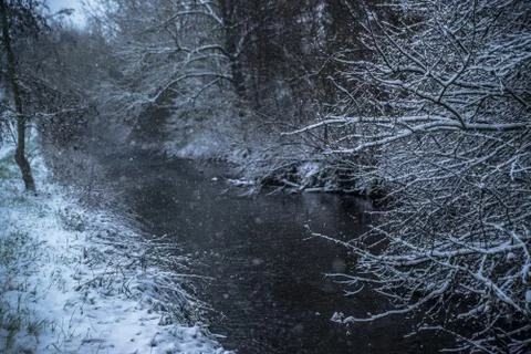 Small river in snowy forest Stock Photos