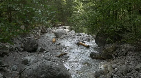 Small river splitting and streaming towards cliff Stock Footage 56163325