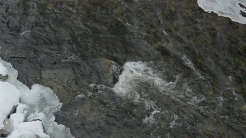 Small river stream in winter cold running creek in slow motion Stock Footage 259229474