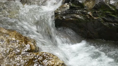 Small river streaming over wet rocks Stock Footage 56163820
