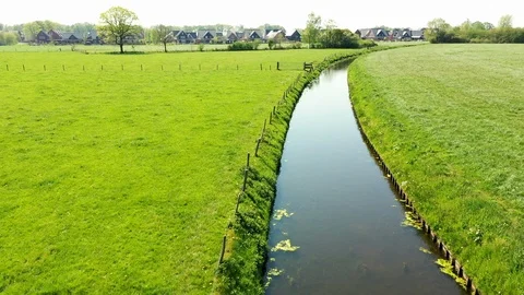 Small river streaming trough typical green Dutch landscape Video stock 111665065