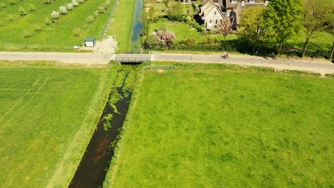 Small river streaming trough typical green Dutch landscape 動画素材 111665455