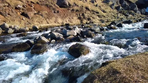 Small river with strong stream flowing down near Kerlingarfoss waterfall in.. Video stock 308815206