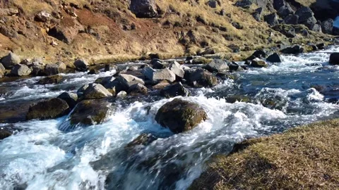 Small river with strong stream flowing down near Kerlingarfoss waterfall in.. Video stock 308815278
