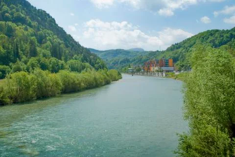 Small river surrounded with lots of plants flowing towards thermal center. Stock Photos