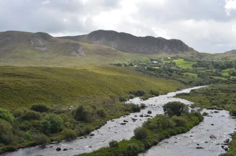 Small River in Vegetation and Mountain Landscape in a National Road in Ireland Stock Photos