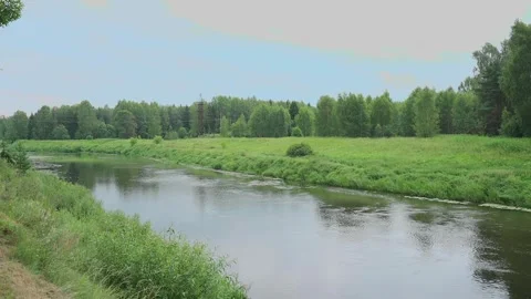 A small river, view from the shore, slow motion camera Video stock 328299393