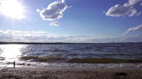 Small river waves splashing on sand shore beach in incredible steady view on Stock Footage 95228900