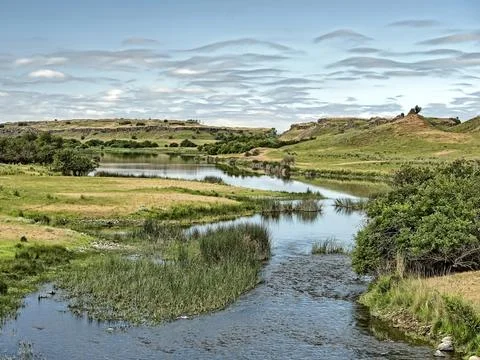 Small river winds through the plateau. Stock Photos