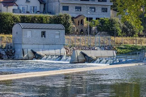 Small riverside utility structure beside flowing water on the Yonne River, .. Stock Photos
