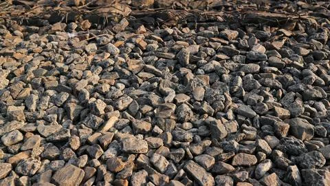 Small road stone background, dark gravel texture, stone pebbles, seamless t.. Stock Photos