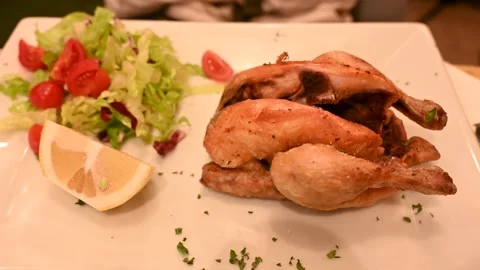 A small roast chicken served in a restaurant. Stock Footage 297414191