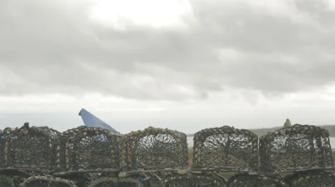 Small Robin bird sitting on lobster creels at a Scottish Harbour Stock Footage 58439389