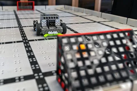 Small robots compete in a technology display at a robotics event in a classro Stock Photos