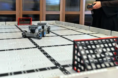 Small robots compete in a technology display at a robotics event in a classro Stock Photos