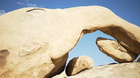 A small rock arch with a saturated sky and clouds for green screen 動画素材 89854882