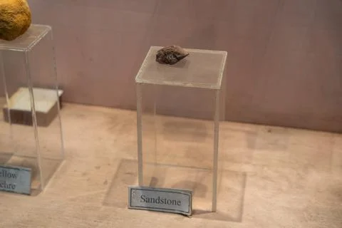 A small rock is on a clear display case. in Chennai Stock-Fotos