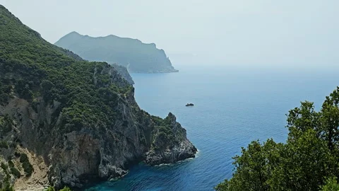 Small rock formation in bay with rugged rocky outcroppings Stock Footage 296355081