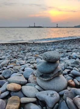 Small rock pile on a beach at sunset Stock Photos