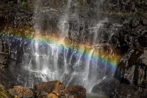 Small rock waterfall creating rainbow Stock Photos