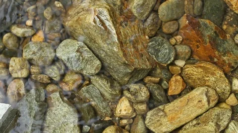 Small Rocks and Pebble Stones on a Creek Spring Stock Footage 93319081