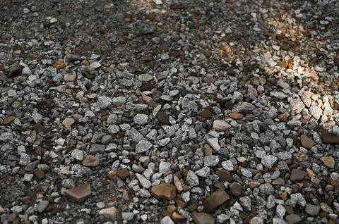 Small rocks and pebbles forming textured ground, natural surface with shado.. Stock Photos