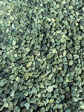 Small rocks cover the ground in a pattern at a construction site in the aft.. Stock Photos