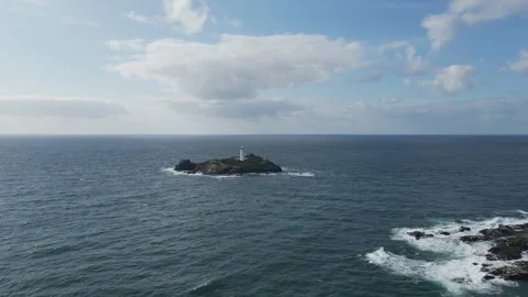 A small rocky island with a lighthouse in the ocean. Stock Footage 285309134