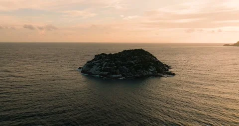 Small rocky island surrounded by ocean at sunset. Seychelles, Mahe. Stock Footage 311347706